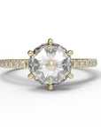 Close up of the Accented Zoe Solitaire Engagement Ring in yellow gold by Fluid Jewellery