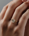 Love Knot split shank diamond solitaire engagement ring featuring a hidden halo and intertwined gold setting on hand.