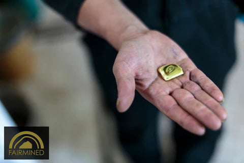 Hand holding fairmined gold