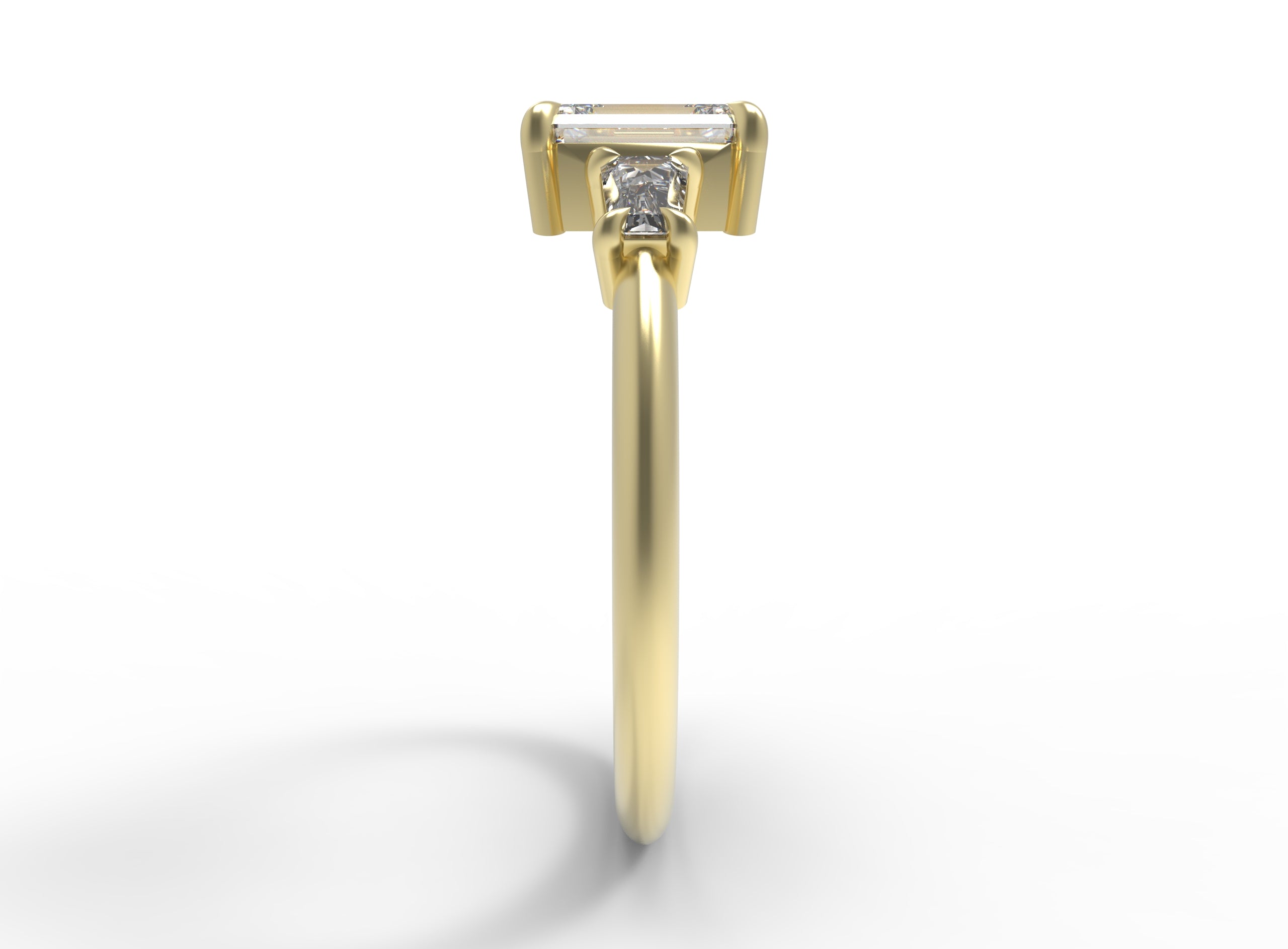 Close up of the Three Stone Adele Solitaire Engagement Ring in yellow gold by Fluid Jewellery 2
