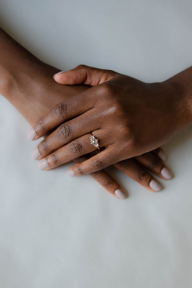 Model wearing the Three Stone Alice Solitaire Engagement Ring in gold by Fluid Jewellery 3