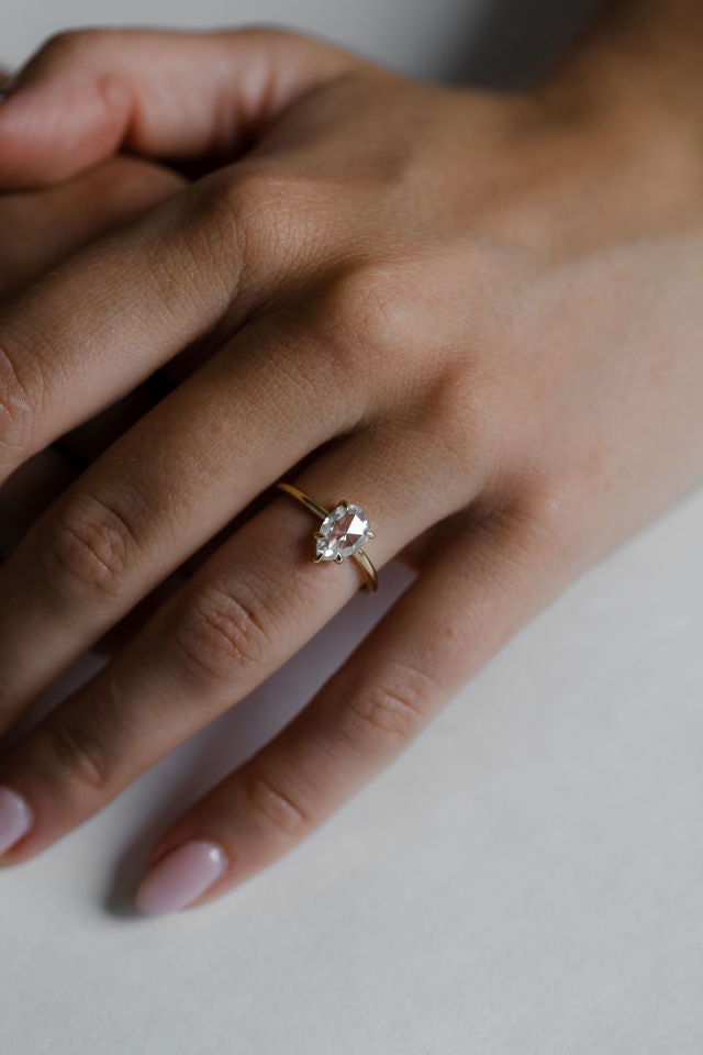 Model wearing the Avery Solitaire Engagement Ring in yellow gold by Fluid Jewellery 2