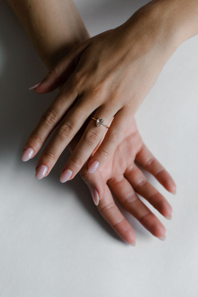 Model wearing the Avery Solitaire Engagement Ring in yellow gold by Fluid Jewellery 3