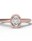 Close up of the Bezel Isla Solitaire Engagement Ring in rose gold by Fluid Jewellery