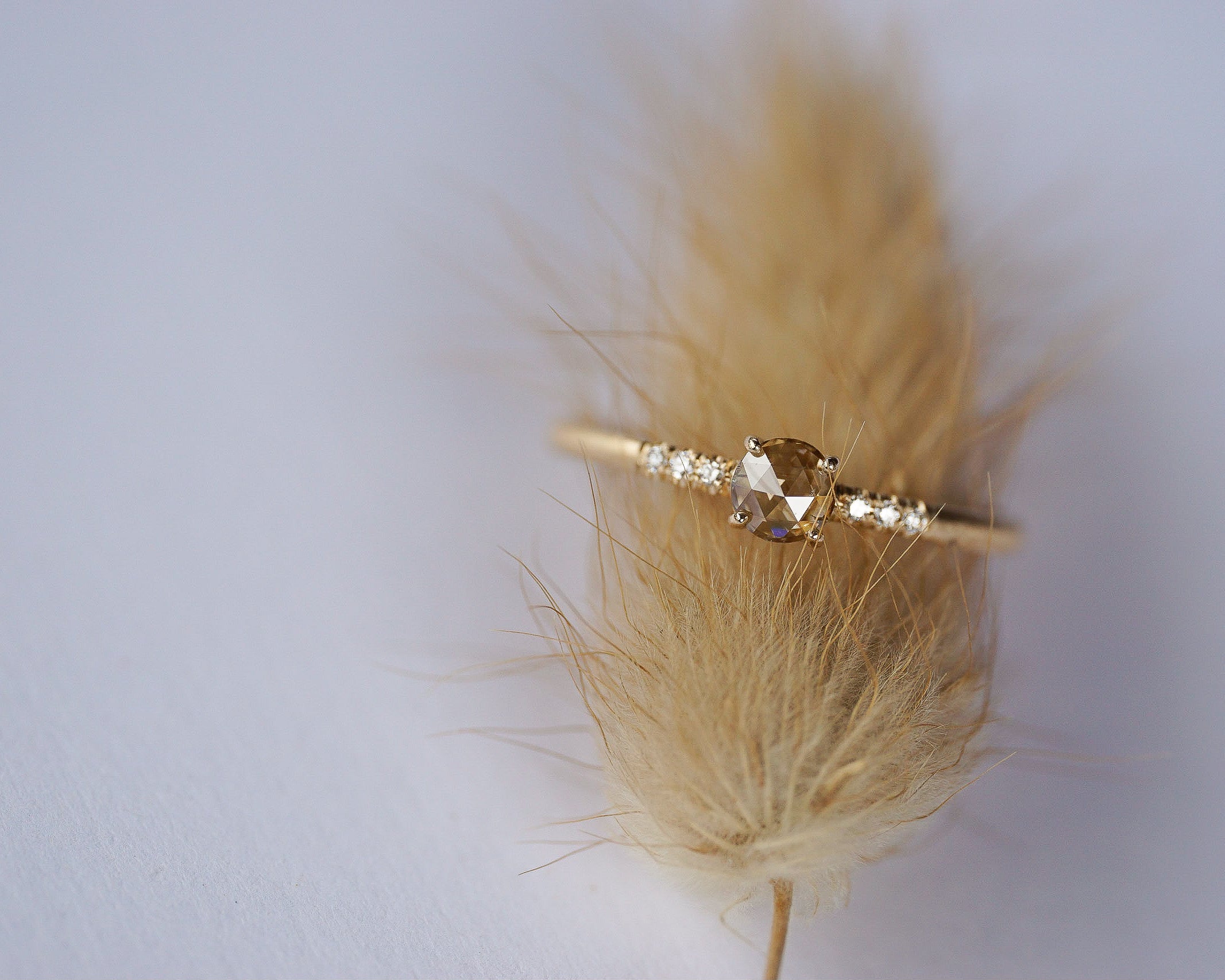 Close up of the Accented Bri Solitaire Engagement Ring in yellow gold by Fluid Jewellery 4