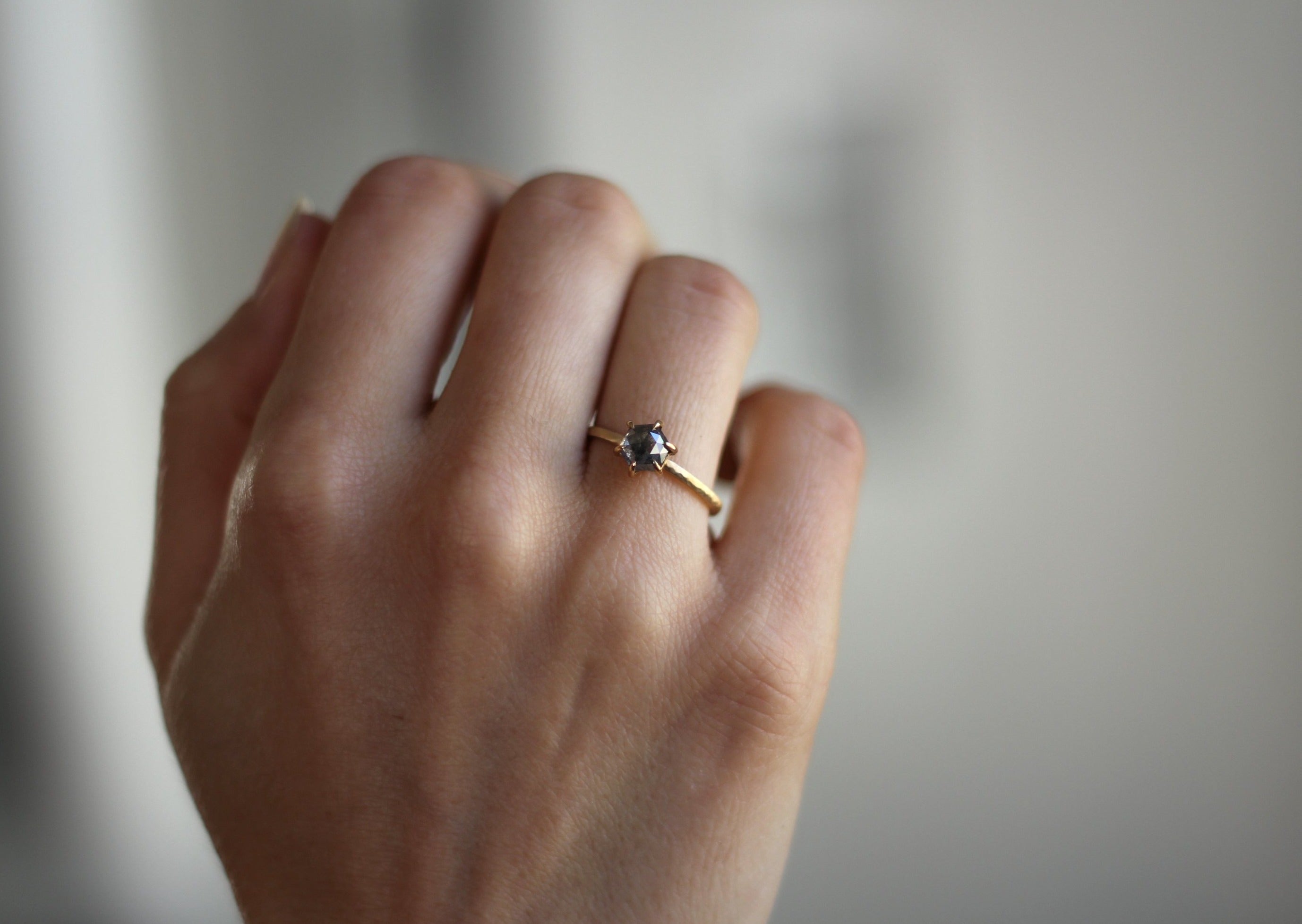 Model wearing the Classic Celeste Solitaire Engagement Ring in yellow gold by Fluid Jewellery