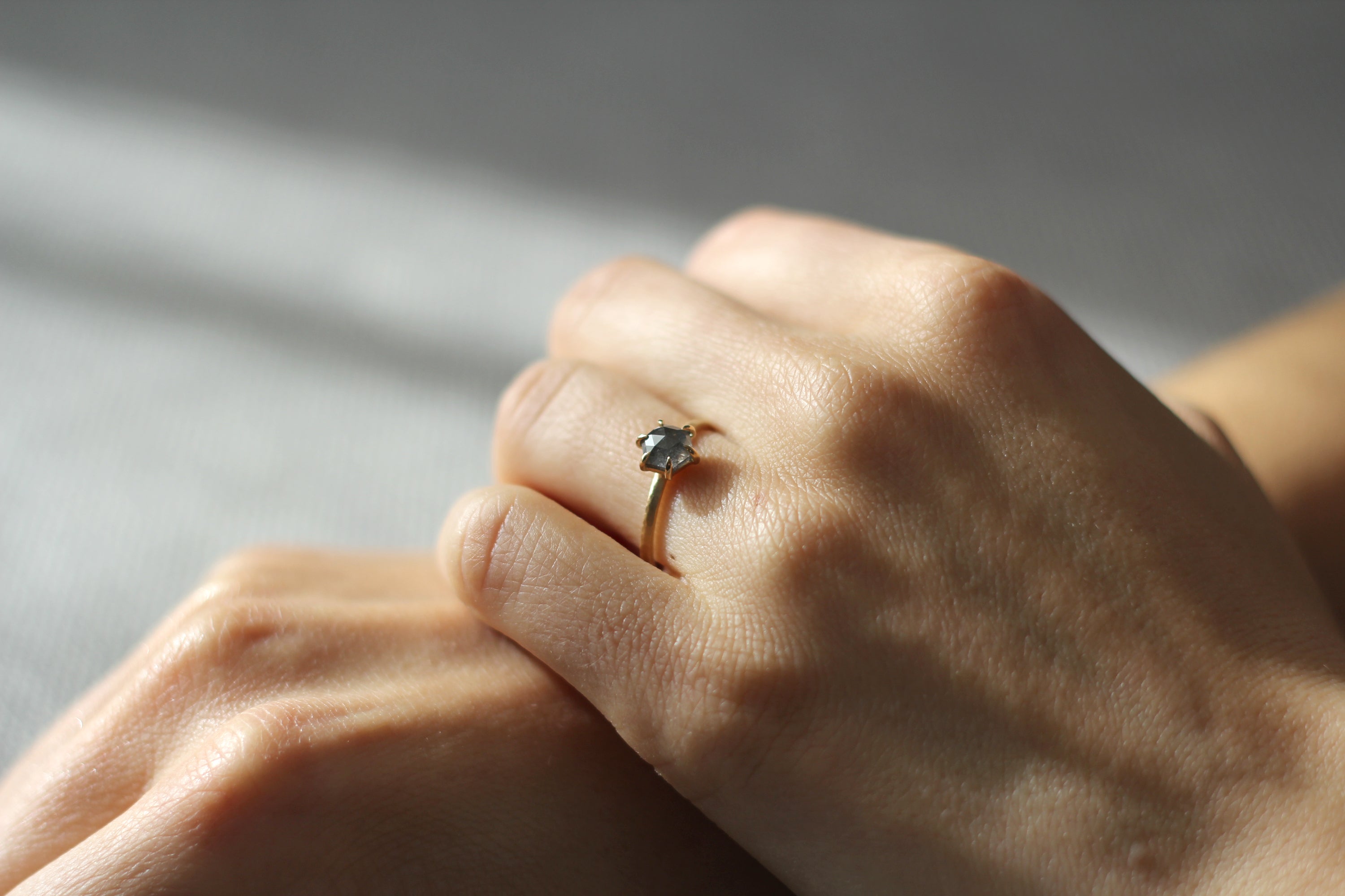Model wearing the Classic Celeste Solitaire Engagement Ring in yellow gold by Fluid Jewellery 2