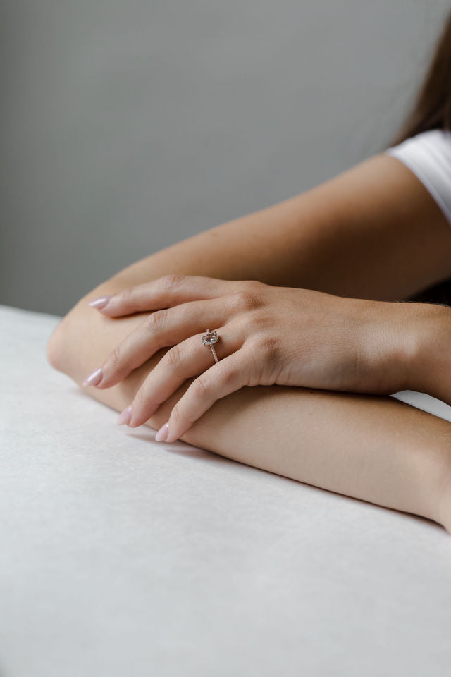 Model wearing the Chloe Solitaire Engagement Ring in gold by Fluid Jewellery 2