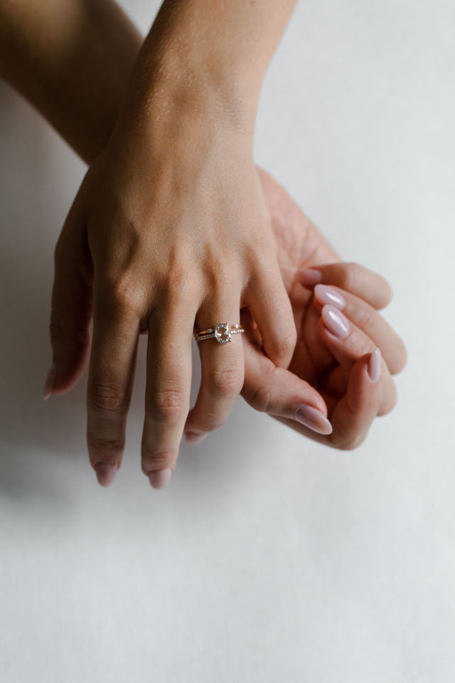 Model wearing the Chloe Solitaire Engagement Ring in gold by Fluid Jewellery