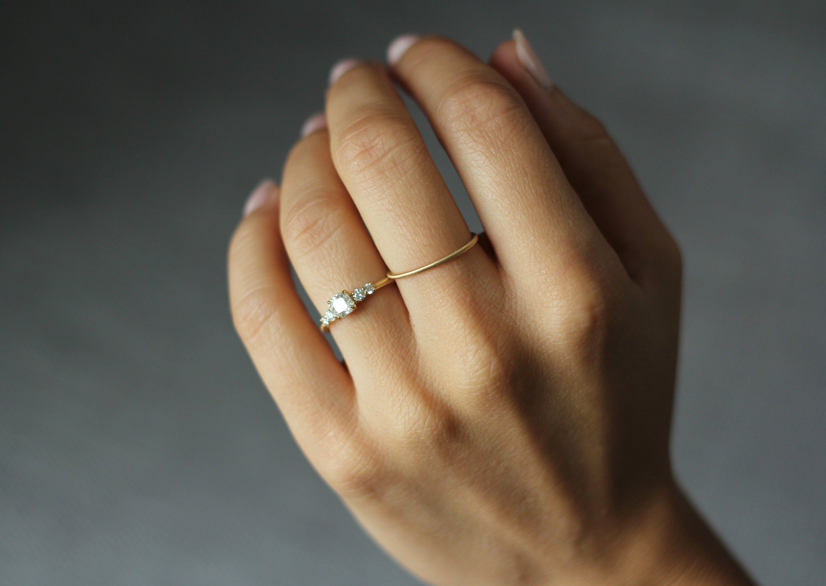 Model wearing the Five Stone Claire Engagement Ring in yellow gold by Fluid Jewellery