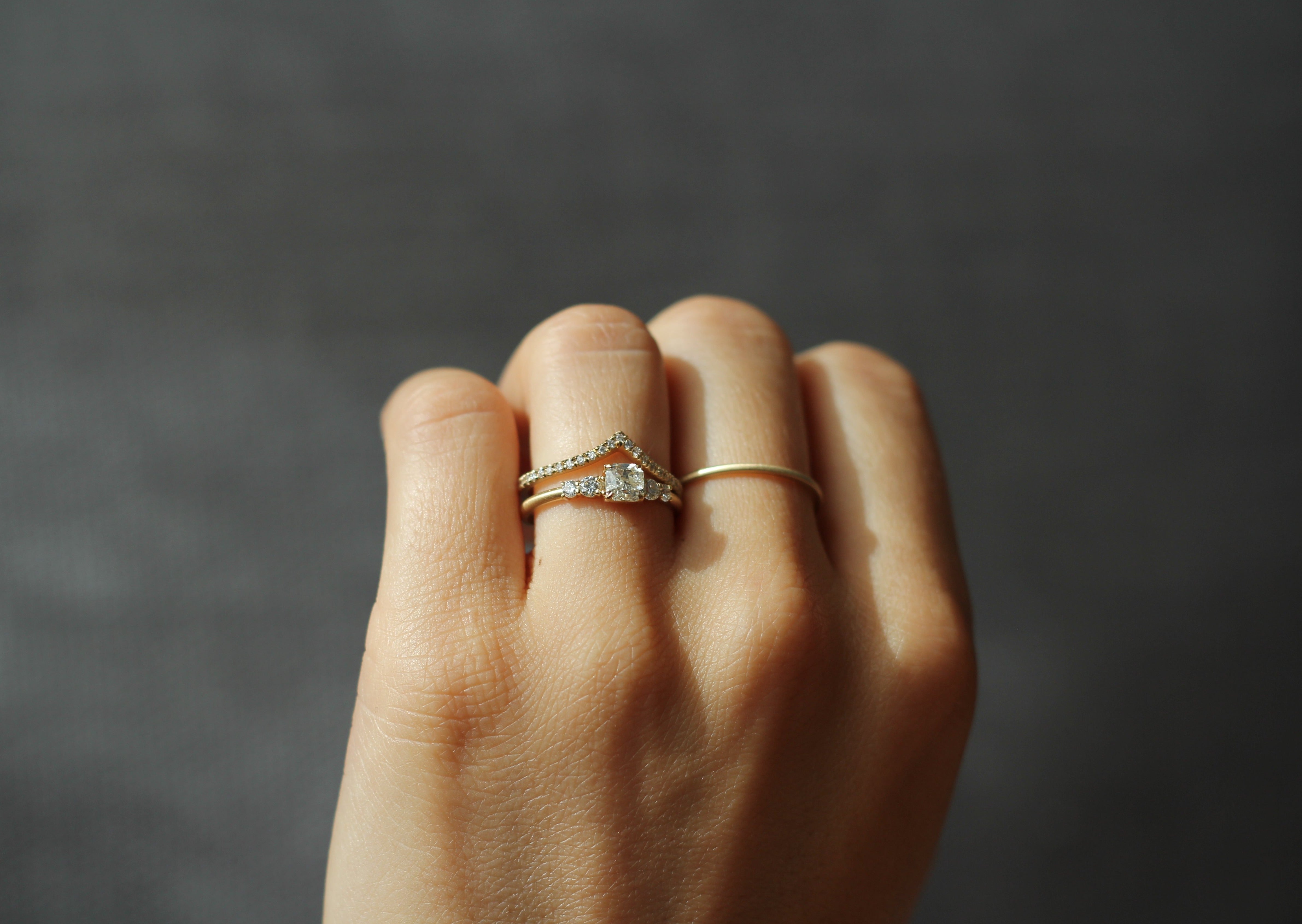 Model wearing the Five Stone Claire Engagement Ring in yellow gold by Fluid Jewellery 2