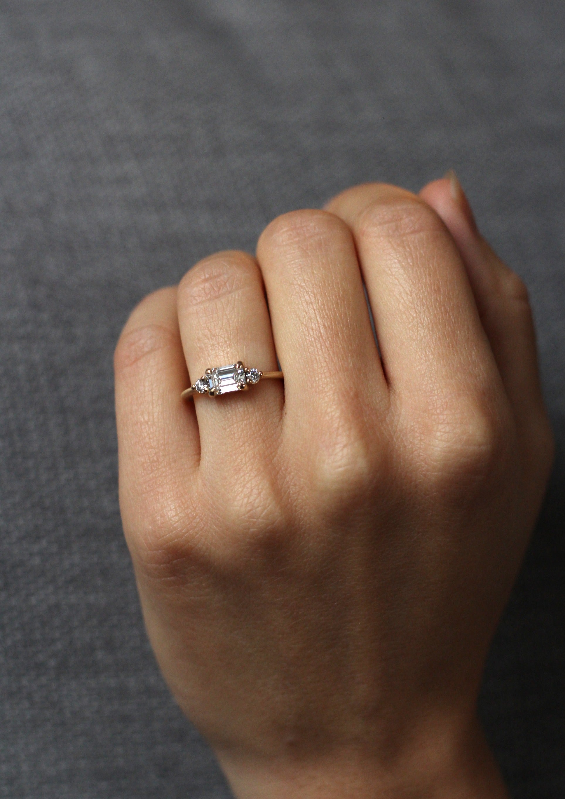 Model wearing the Five Stone Cora Engagement Ring in yellow gold by Fluid Jewellery