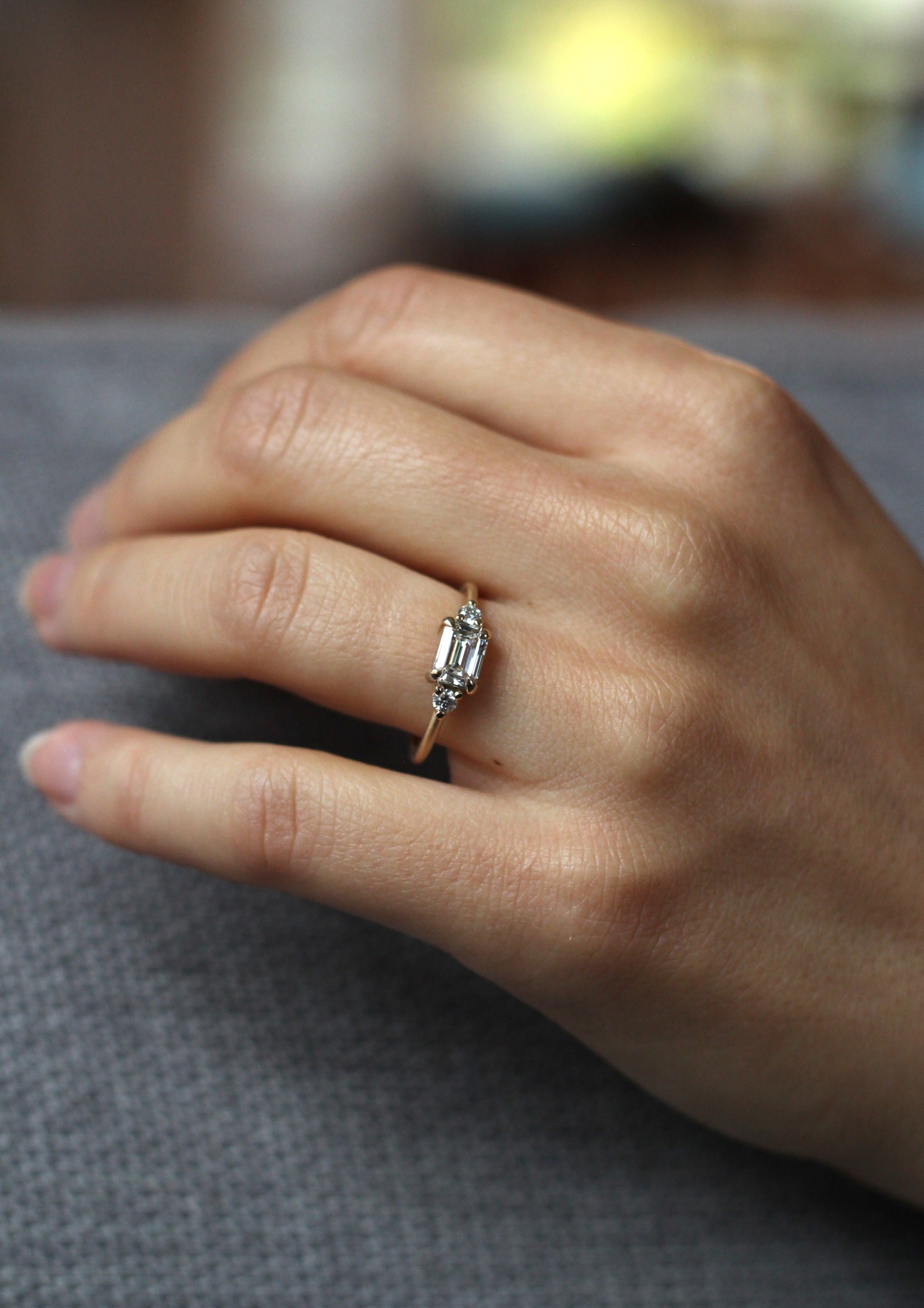 Model wearing the Five Stone Cora Engagement Ring in yellow gold by Fluid Jewellery 2