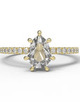 Close up of the Accented Daphne Solitaire Engagement Ring in yellow gold by Fluid Jewellery