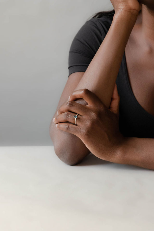 Model wearing the Accented Edith Solitaire Engagement Ring in gold by Fluid Jewellery  2