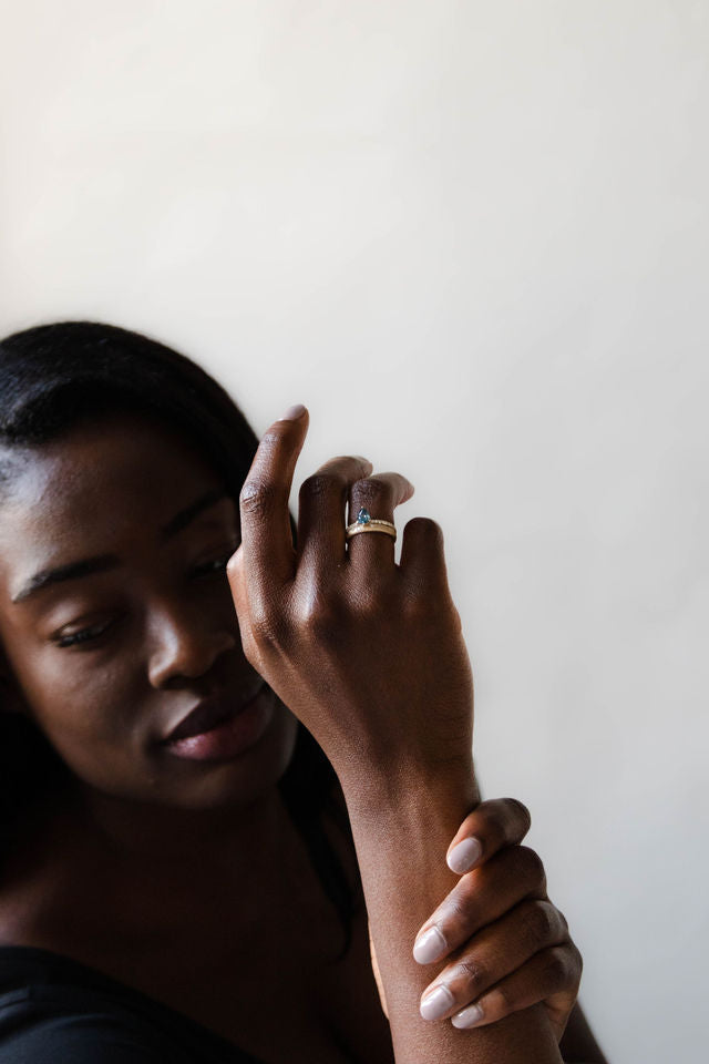 Model wearing the Accented Edith Solitaire Engagement Ring in gold by Fluid Jewellery  4