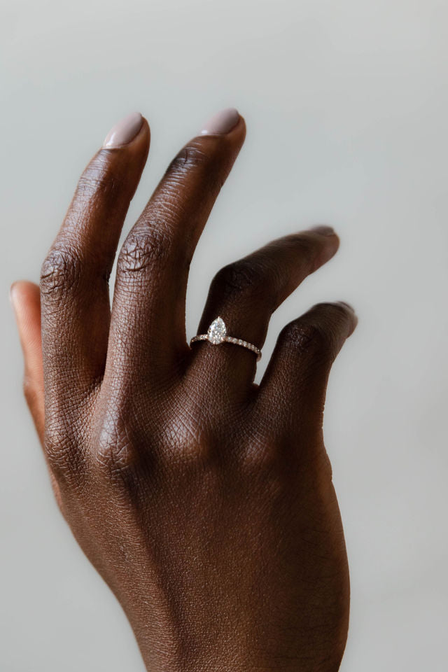 Model wearing the Accented Edith Solitaire Engagement Ring in gold by Fluid Jewellery