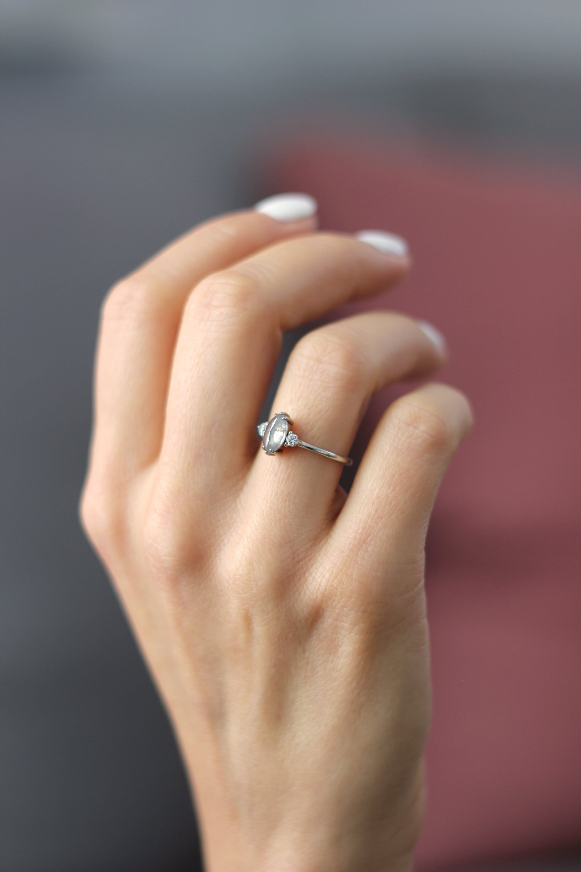 Model wearing the Three Stone Elizabeth Engagement Ring in yellow gold by Fluid Jewellery 2