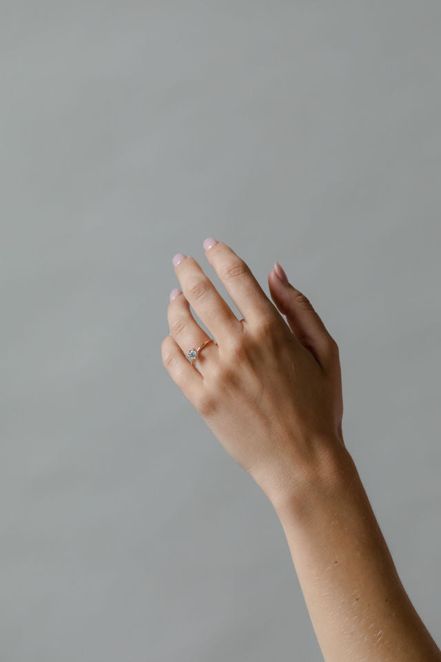 Model wearing the Classic Esther Engagement Ring in yellow gold by Fluid Jewellery