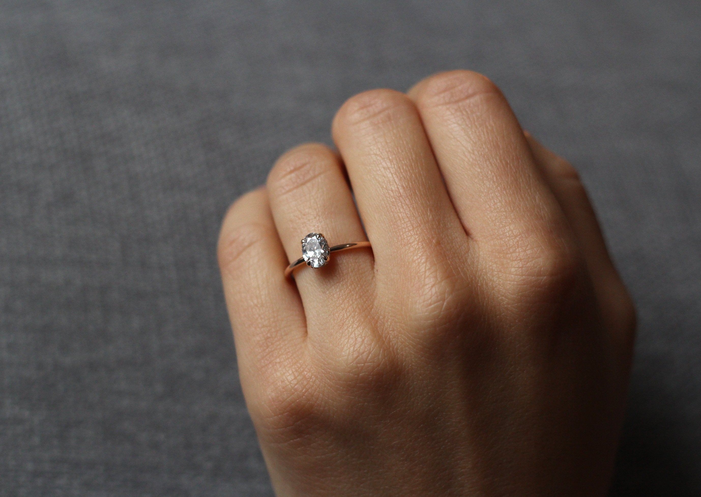 Model wearing the Hidden Halo Love Nest Ring in rose gold by Fluid Jewellery