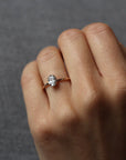 Model wearing the Hidden Halo Love Nest Ring in rose gold by Fluid Jewellery