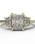 Close up of the Three Stone Merike Engagement Ring in yellow gold by Fluid Jewellery