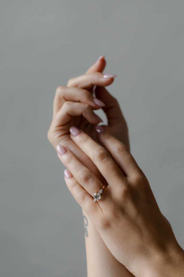 Model wearing the Three Stone Sadie Engagement Ring in yellow gold by Fluid Jewellery 2