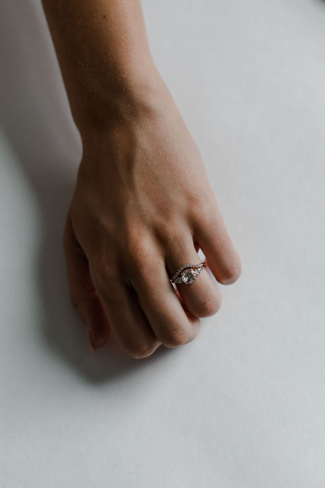 Model wearing the Three Stone Sadie Engagement Ring in yellow gold by Fluid Jewellery 3