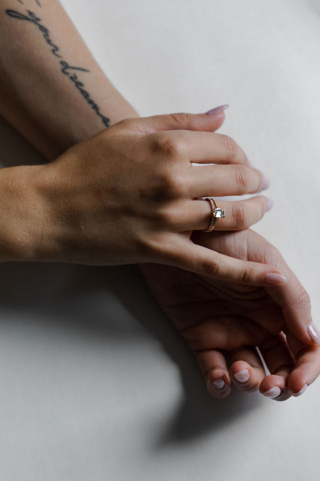 Model wearing the Cathedral Sage Solitaire Engagement Ring in yellow gold by Fluid Jewellery 3
