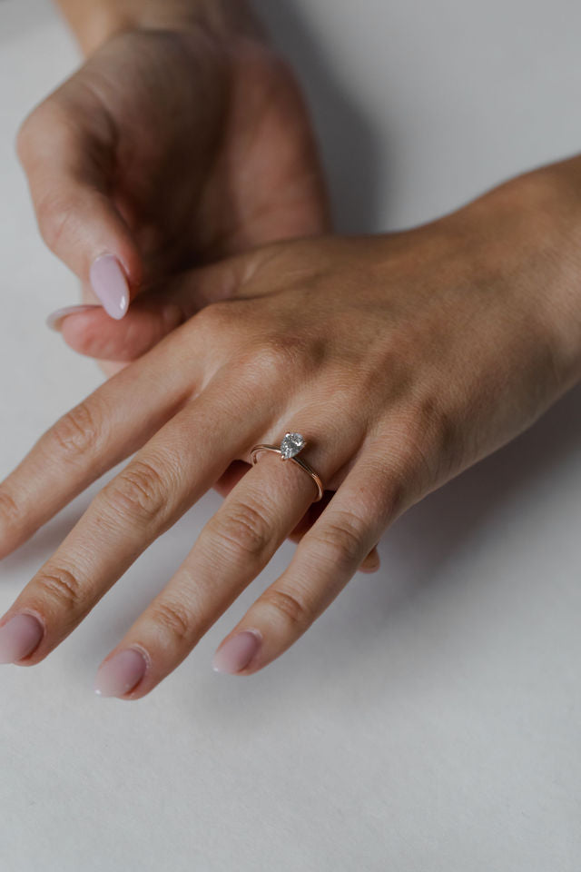 Model wearing the Classic Sula Solitaire Engagement Ring in gold by Fluid Jewellery 2