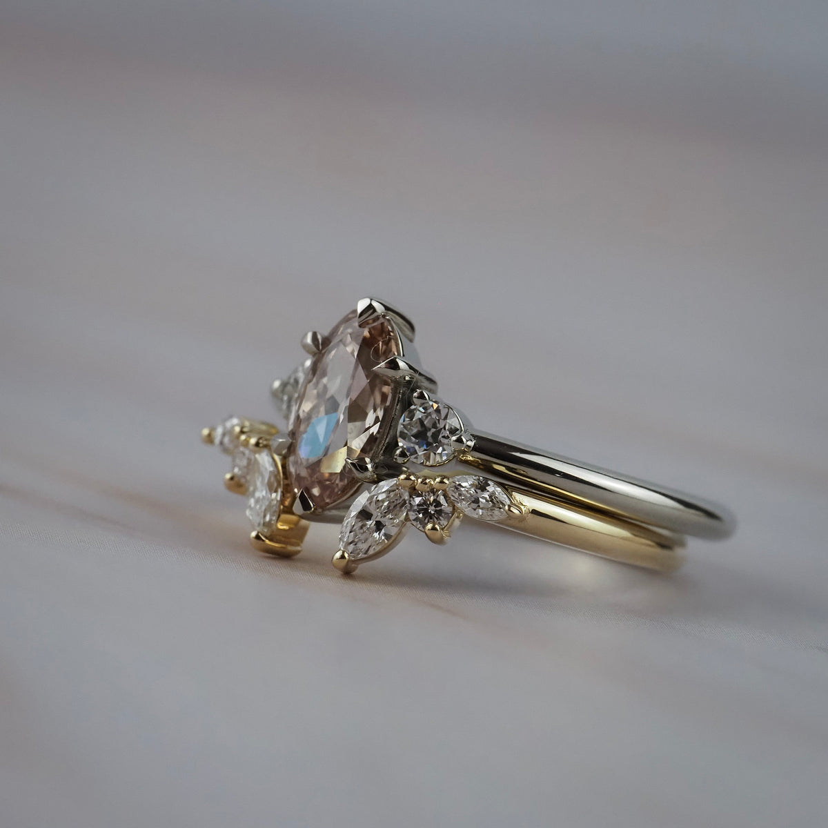 Close-up of an Aster diamond wedding band with marquis and round diamonds with an engagement ring 