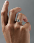 Close-up of a woman wearing the Cala tulip style solitaire with an antique floral filigree inspired platinum and gold setting and round Old European cut diamond. 