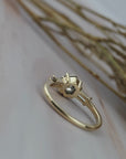 Back profile of the Esme hexagon-shaped salt and pepper diamond engagement ring showing the gold setting and tapered baguette diamonds. 