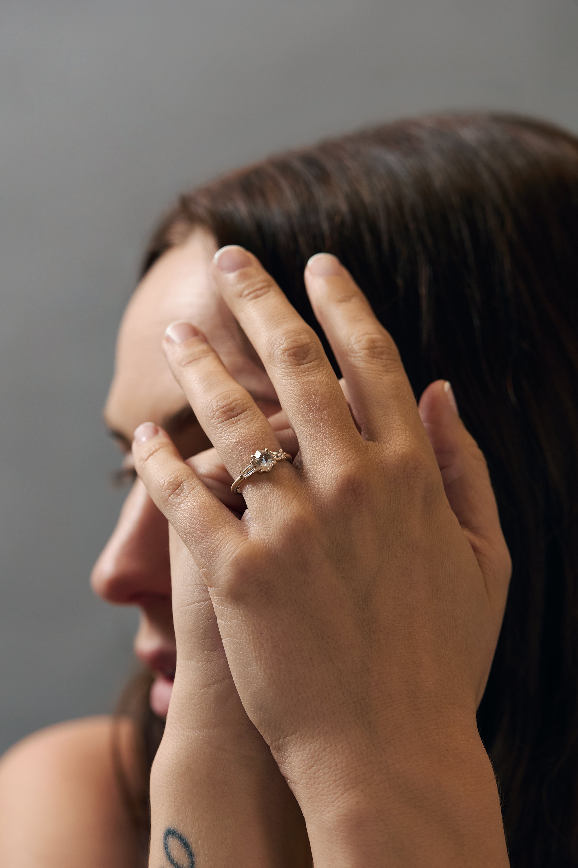 Back profile of the Esme hexagon-shaped salt and diamond engagement ring showing the gold setting and tapped baguette diamonds.