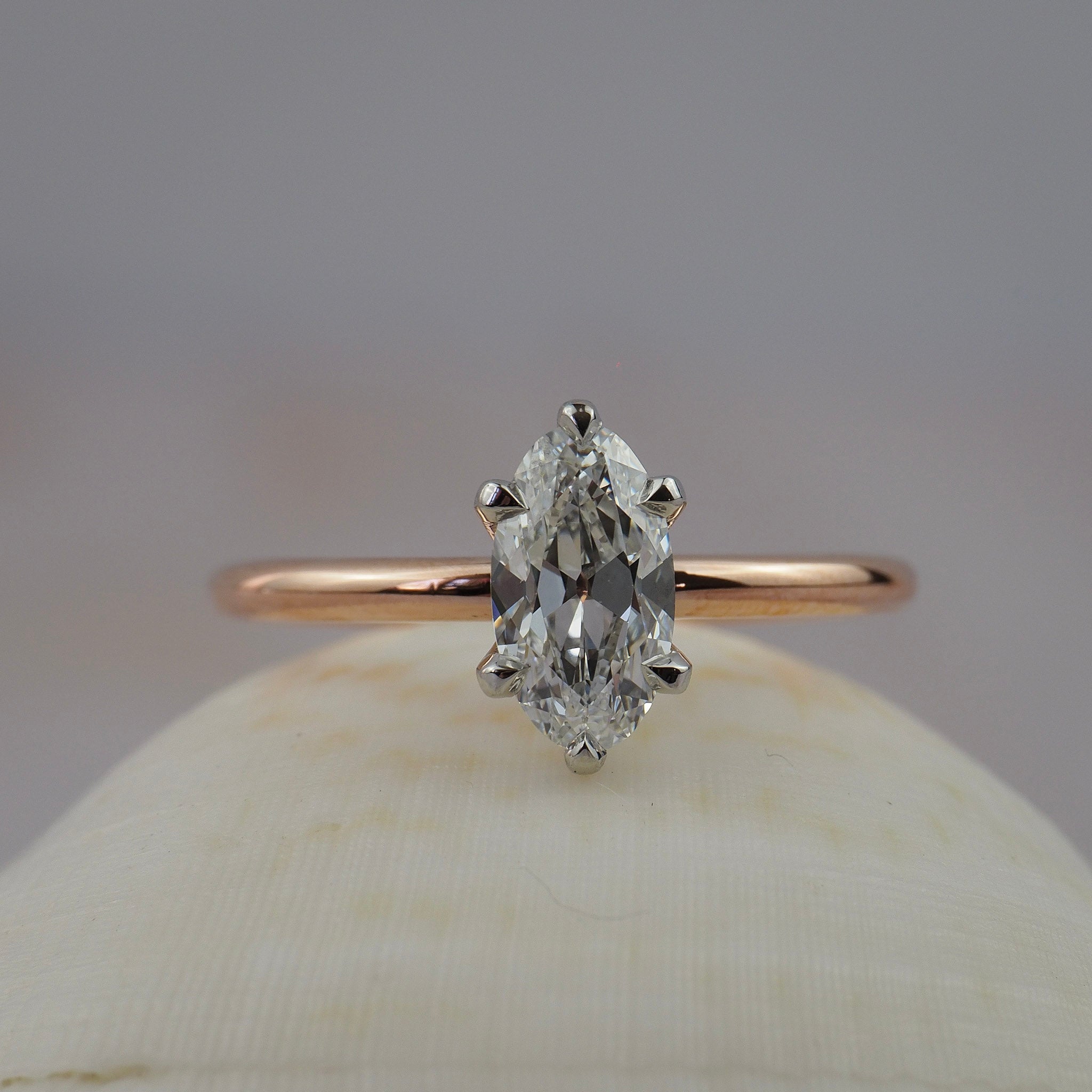Lena six-claw solitaire engagement ring featuring a moral shaped antique cut Old European diamond in two-tone platinum and rose gold setting.