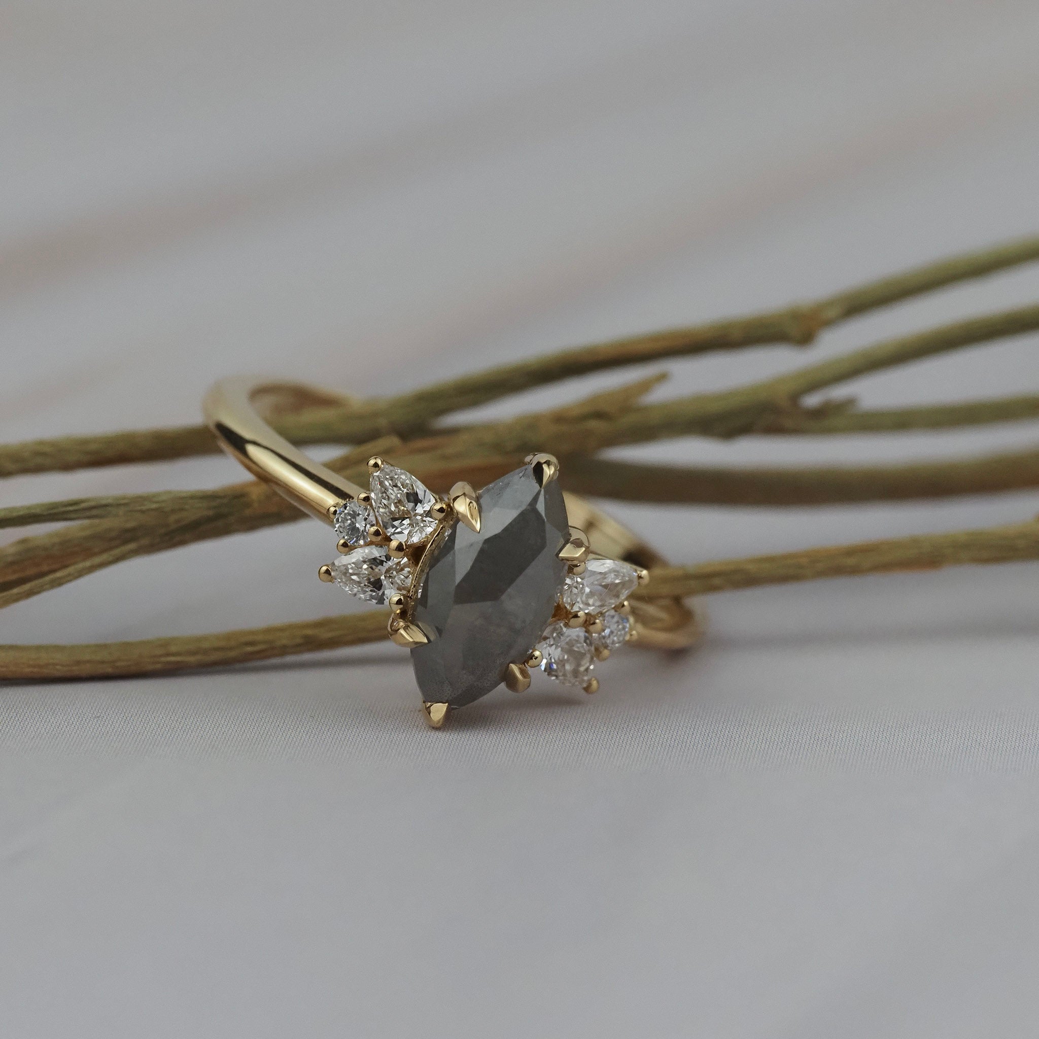 Close-up detail of the Meghan salt and pepper marquise shaped rose cut cluster engagement ring showing its handcrafted gold setting.
