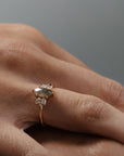 Close-up of the Meghan salt and pepper marquise shaped rose cut cluster engagement ring worn on a woman's finger.