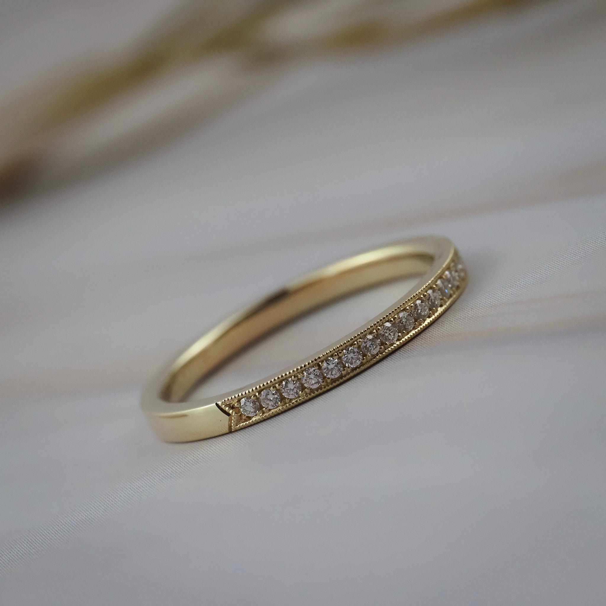 Handcrafted milgrain wedding band in Fairmined yellow gold featuring Canadian diamonds.