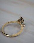 Close-up of the back of the Millie cluster solitaire showing the setting, side profile, and milgrained beaded gold band. 
