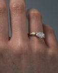 Close-up video of a woman wearing the Magnolia half bezel solitaire, featuring an elongated Old European cushion cut diamond and hand engraved magnolia flowers. 