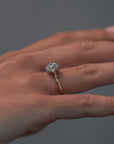 Close-up video of a woman wearing the Cala tulip-styles solitaire, featuring a two tone platinum and gold setting with a round Old European cut diamond. 