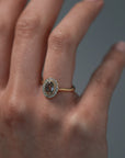 Close-up video of woman wearing the Air halo solitaire with a champagne toned Australian salt and pepper rose cut diamond surrounded by round Canadian diamonds. 