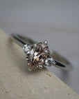 Rebecca three stone engagement ring featuring a champagne  toned moval cut diamond accented by white full cut diamonds.