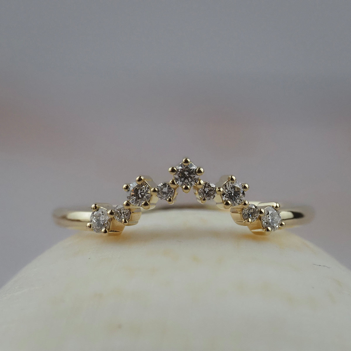 Snowflake curved gold wedding band featuring Canadian diamonds in a a snowflake inspired design.