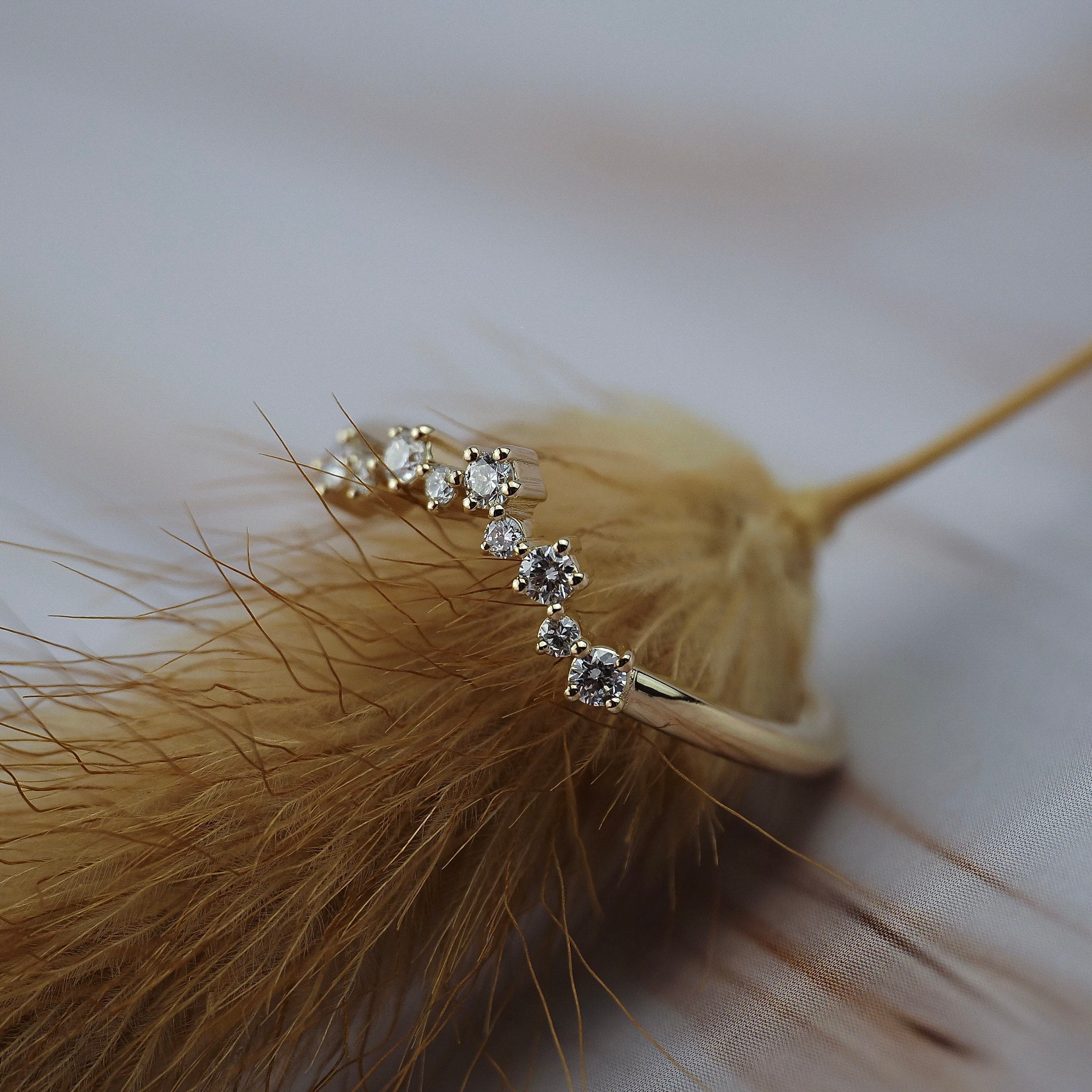 Close-up of the Snowflake diamond wedding band showing its delicate snowflake-inspired gold design and Canadian diamonds.