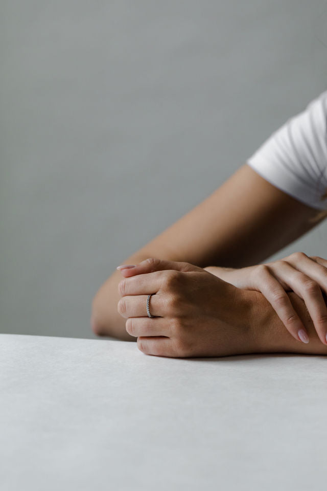 Close up of model hand wearing the Classic Annalise womens wedding band by Fluid Jewellery in gold