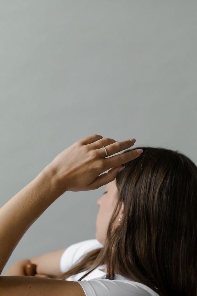 Close up of model hand wearing the classin Evelyn womens wedding band by Fluid Jewellery in gold