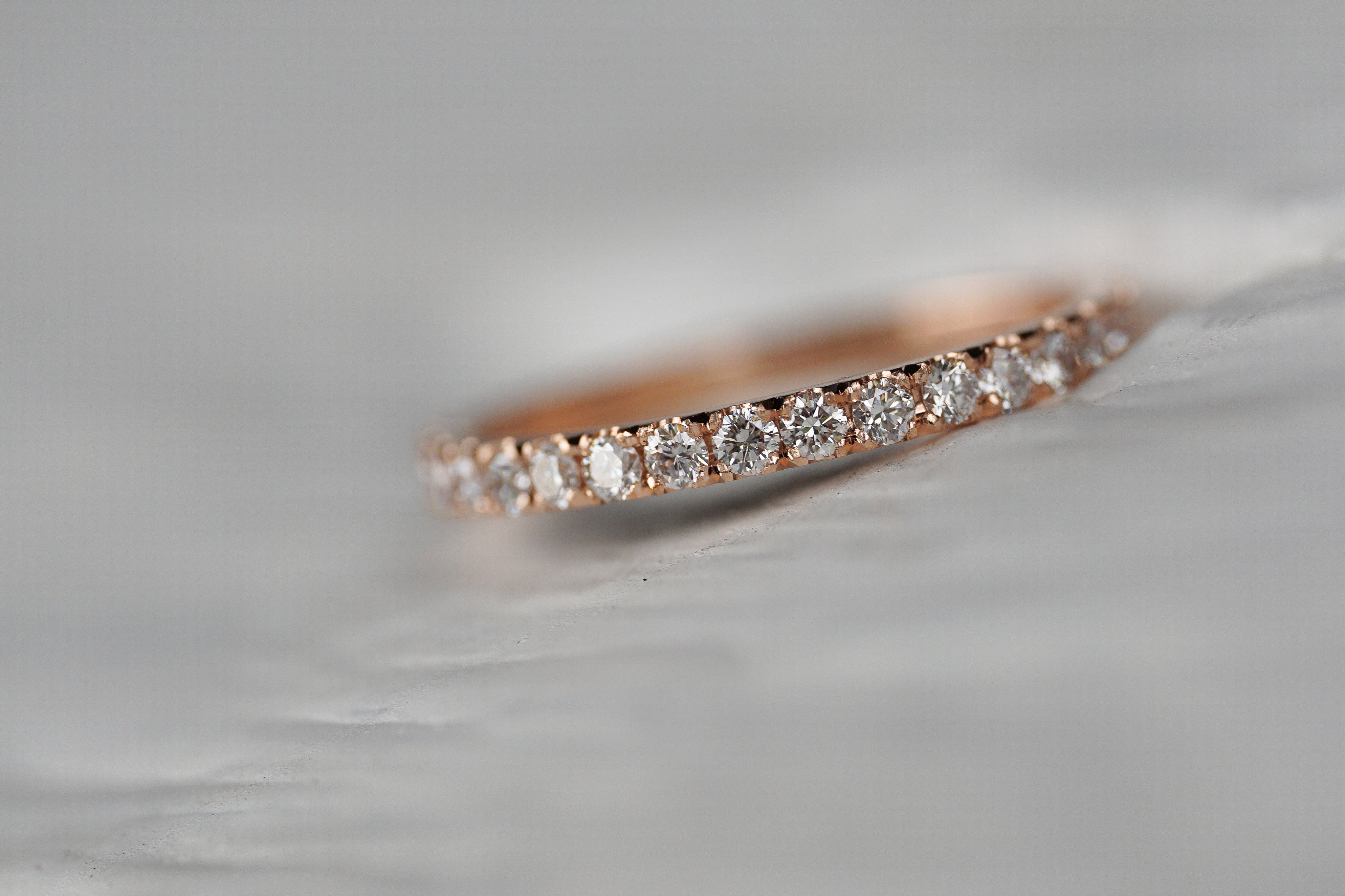 Close up of the classic Eternity womens wedding band by Fluid Jewellery in yellow gold 4