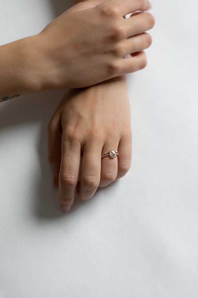 Close up of model hand wearing the open Mara womens wedding band by Fluid Jewellery in yellow gold 4