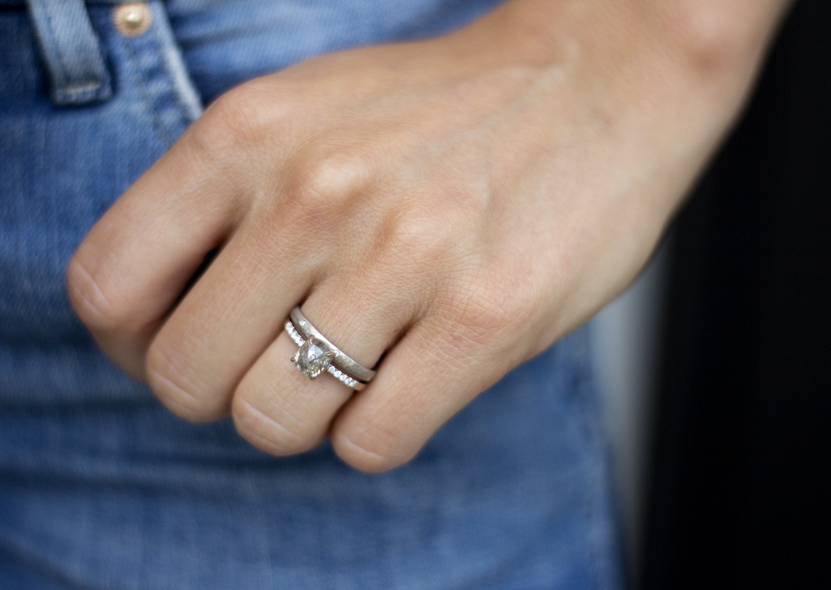 Close up of model hand wearing the Starlight womens wedding band by Fluid Jewellery in gold